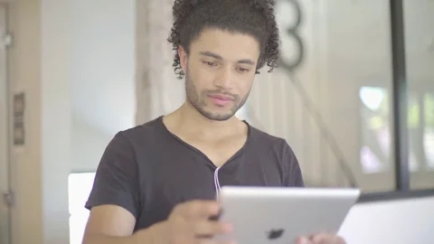 Young man using digital tablet Stock Footage 75795048