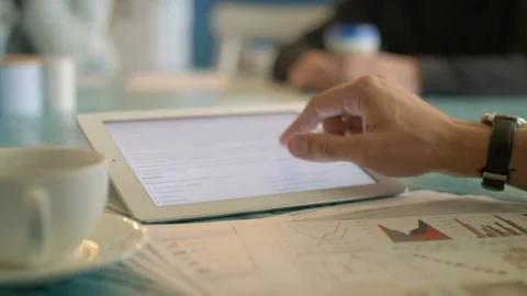 Young man Using Digital Tablet Ipad Computer In Cafe Stock Footage 97582744