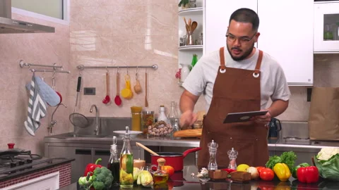 Young man using digital tablet checking list of vegetables and ingredients Video stock 134414746