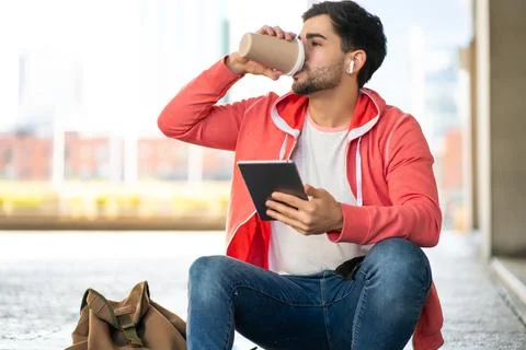 Young man using digital tablet outdoors. Stock Photos