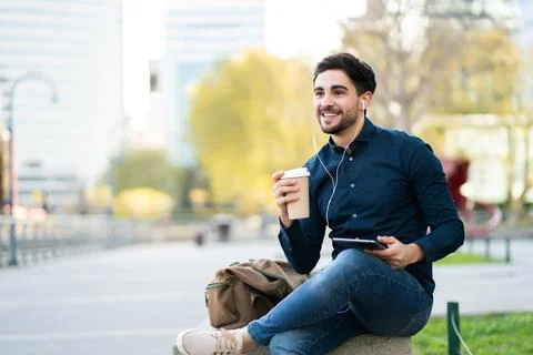 Young man using digital tablet outdoors. Stock Photos