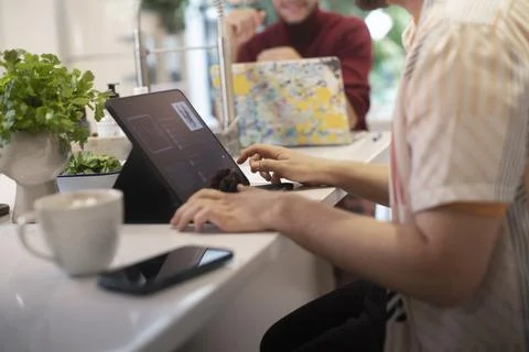 Young man using digital tablet at kitchen counter 스톡 사진