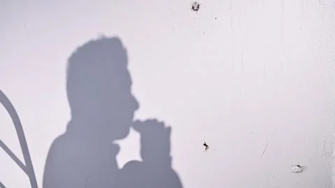 Young man using an e-cigarette on white background. Stock Photos