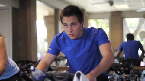 Young Man Using Exercise Bike Stock Footage 6731996