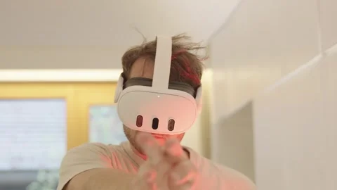 Young man using gestures to control a virtual reality environment while wearing 스톡 동영상 335196335