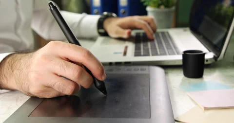 Young man using a graphic tablet with laptop 動画素材 139770732