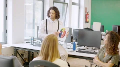 Young man using graphics while talking in a coworking meeting Stock Footage 257307265