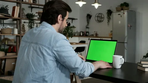 Young man using green screen chroma key laptop typing working in light office Stock Footage 144236459