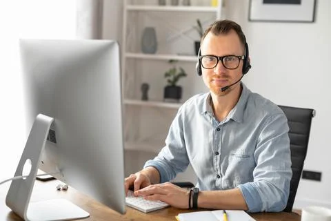 A young man using handsfree headset Foto stock