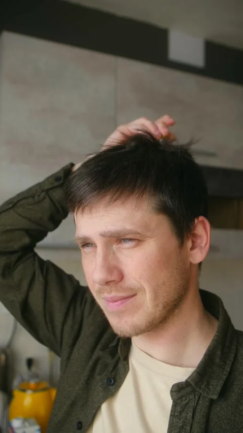 Young man using a head massager for scalp relaxation Stock-Footage 337828609