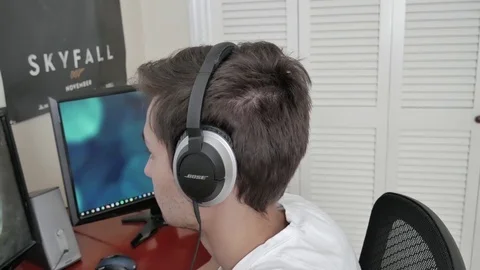 A young man using headphones 스톡 동영상 75488698