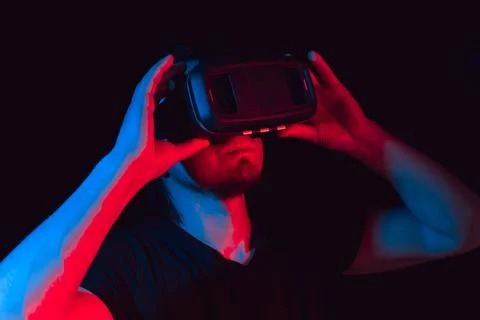 A young man using high-tech virtual reality glasses. close up Stock Photos