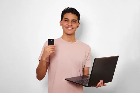 Young man using his card in online shopping Stock Photos