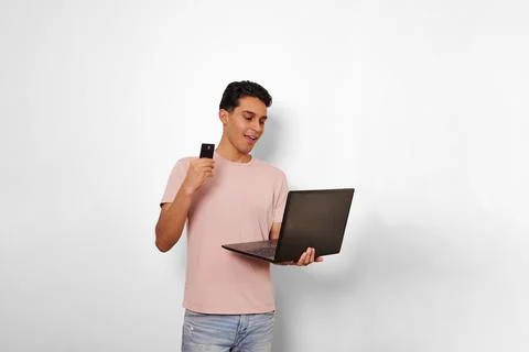 Young man using his card in online shopping Stock Photos