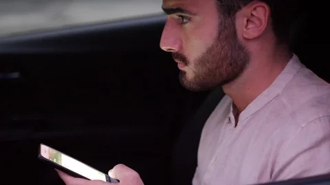 Young Man Using his Cell Phone Driving a Car Stock Footage 80957266