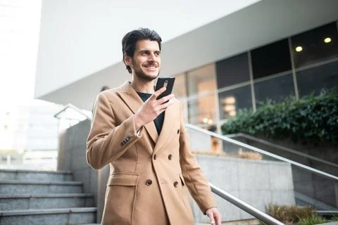 Young man using his cellphone outdoor Stock Photos
