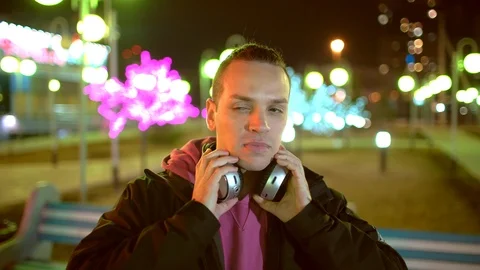 Young man using his headphones in the street. technology, internet Stock Footage 88860617
