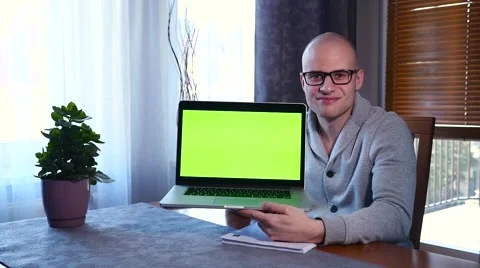 Young man using his laptop. He is showing the screen. Green screen. Stock Footage 61281183