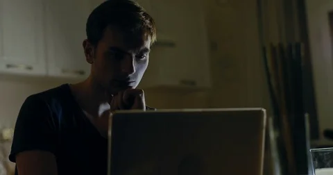The young man using his laptop late at night Stock Footage 72249632