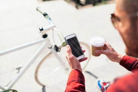 Young man using his mobile in the street. Stock Photos