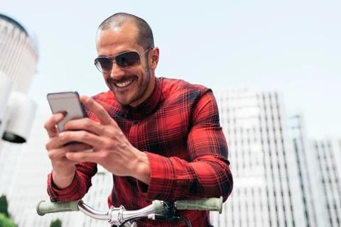 Young man using his mobile in the street. Stock Photos
