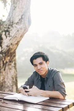 Young man using his mobile device in a park Fotos Stock