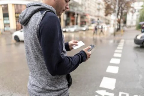 Young man using his mobile in the street Stock Photos