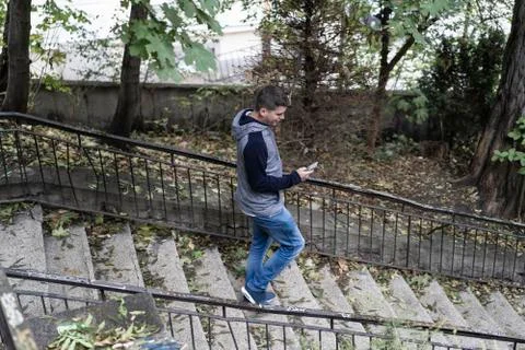 Young man using his mobile in the street Stock Photos