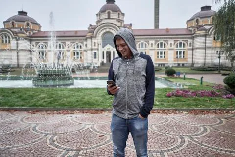 Young man using his mobile in the street Stock Photos