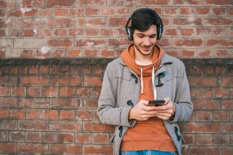 Young man using his mobile phone. Stock Photos