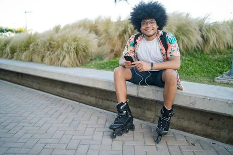 Young man using his mobile phone outdoors. Stock Photos