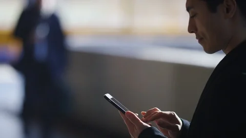 Young man using his phone outdoors Stock Footage 85590922