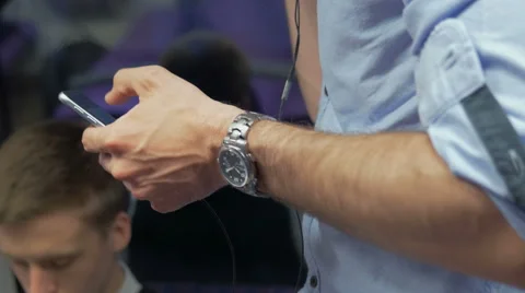 Young man using his smartphone to cummunicate with friends Stock Footage 67261177