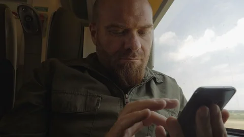 Young man using his smartphone traveling by train Video stock 96330071