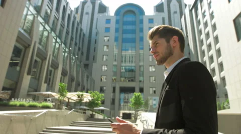 Young man using his tablet in front of a business center Stock Footage 68591672