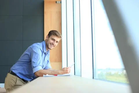 Young man using his tablet in the office. Stock Photos
