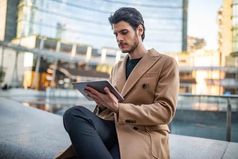 Young man using his tablet outdoor Stock Photos