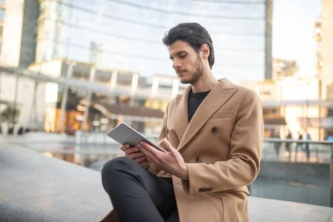 Young man using his tablet outdoor Fotos Stock