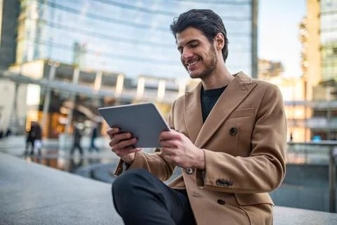 Young man using his tablet outdoor 写真素材
