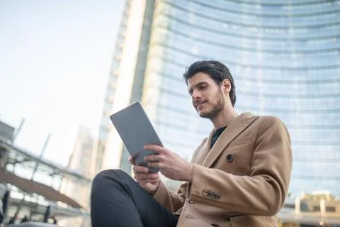 Young man using his tablet outdoor Stock Photos