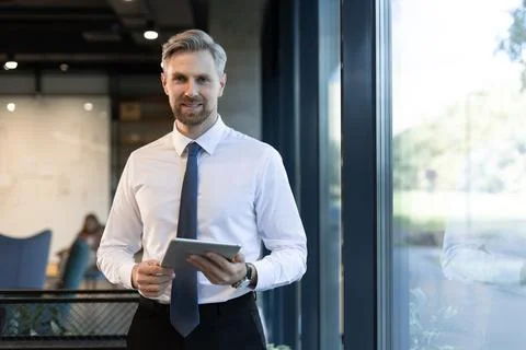 Young man using his tablet in the office. Stock Photos