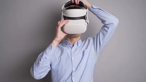 Young man using his VR headset for watching the 360 video while at home in the Video stock 166459013