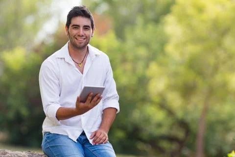 Young man using internet outdoor in the park Stock Photos