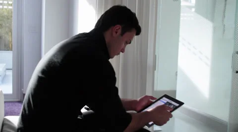 Young Man Using iPad/Tablet Computer in Modern Setting Vídeo Stock 30374768