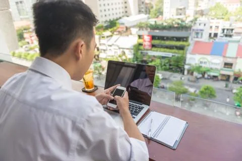 Young man using laptop and smartphone Stock Photos