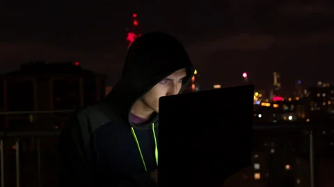 Young man using laptop on balcony at night Stock Footage 138719654