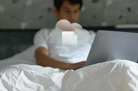 Young man using laptop with cloud icon emerging for digital connectivity an.. Foto stock