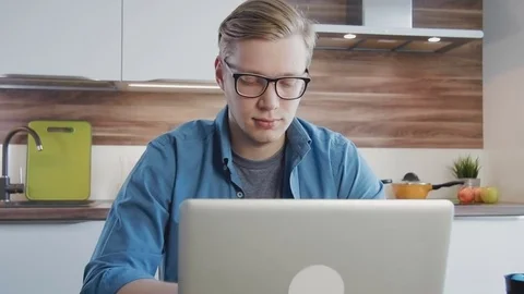 Young man using laptop computer at home Stock Footage 75448800