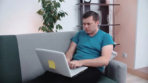 Young man using laptop computer at home. Stock Footage 148570567