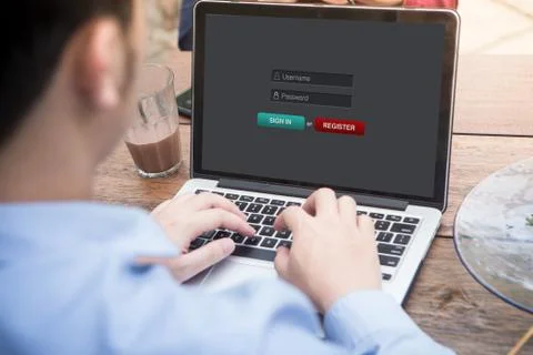 Young man using laptop / computer to sign in membership username password concep Stock Photos